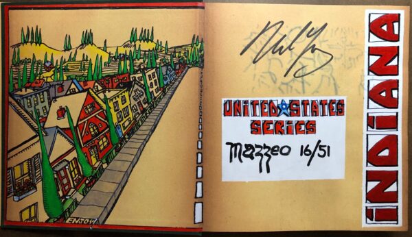 A book with graffiti and a drawing of a street.