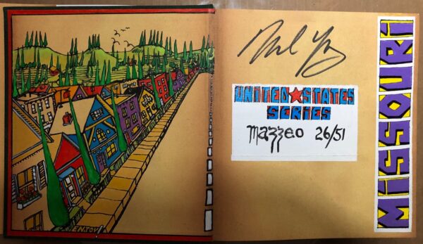 A book with graffiti on the cover and two autographs.