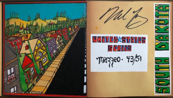 A book with a drawing of a street and buildings.