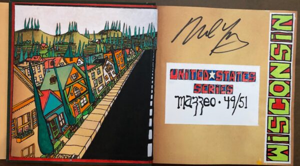 A book with graffiti on the cover and an autograph of a person.