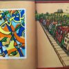 A book with two pictures of houses and trees.